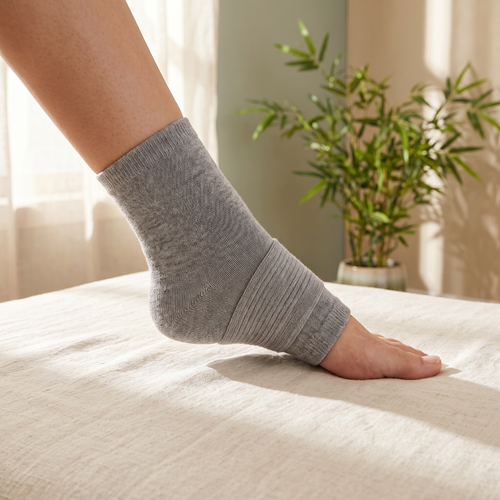 Foot wearing a Bambu open-toe ankle compression sleeve, toes and heel exposed